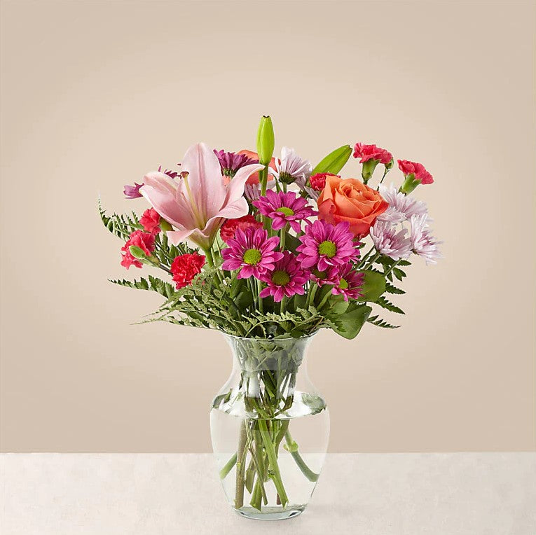 
                  
                    Flash of love Flowers Comfortable Bouquet And Vase, Blooms With Vibrant Color And a Sweet Sophistication To Make An Unforgettable Impression! Pink Lilies Dance Over The Distinctive Arrangement Of This Flower Bouquet, Which Is Surrounded By Orange Roses, Lavender Cushion Poms, Hot Pink Carnations, And Rich Greenery. Bouquets Flowers in Coral Gables, Miami, Delivery Flowers, Florist in Coral Gables.
                  
                