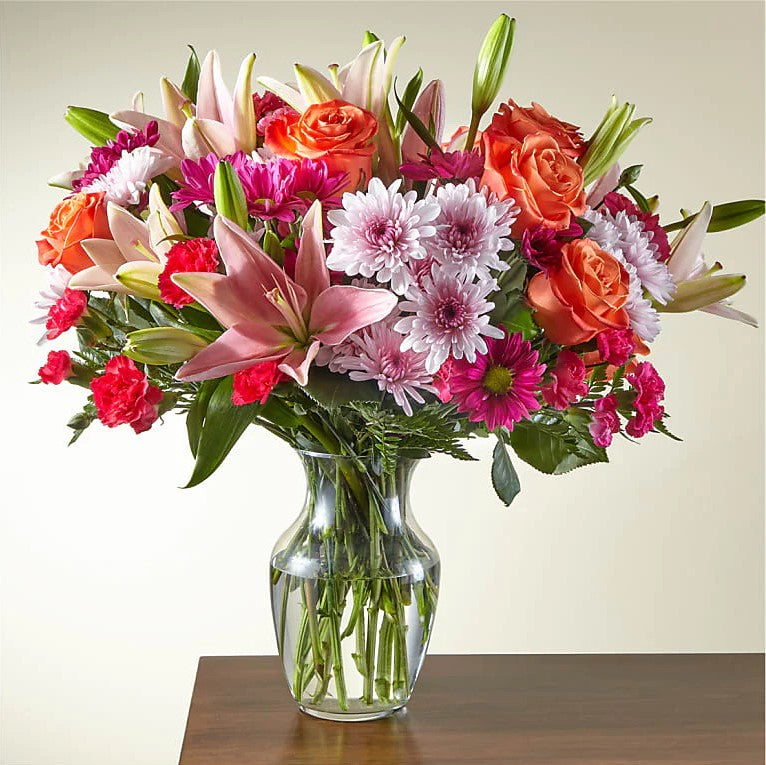 
                  
                    Flash of love Flowers Surprising Bouquet And Vase, Blooms With Vibrant Color And a Sweet Sophistication To Make An Unforgettable Impression! Pink Lilies Dance Over The Distinctive Arrangement Of This Flower Bouquet, Which Is Surrounded By Orange Roses, Lavender Cushion Poms, Hot Pink Carnations, And Rich Greenery. Bouquets Flowers in Coral Gables, Miami, Delivery Flowers, Florist in Coral Gables.
                  
                