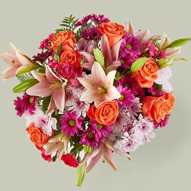 
                  
                    Flash of love Flowers Bouquet And Vase, Blooms With Vibrant Color And a Sweet Sophistication To Make An Unforgettable Impression! Pink Lilies Dance Over The Distinctive Arrangement Of This Flower Bouquet, Which Is Surrounded By Orange Roses, Lavender Cushion Poms, Hot Pink Carnations, And Rich Greenery. Bouquets Flowers in Coral Gables, Miami, Delivery Flowers, Florist in Coral Gables.
                  
                