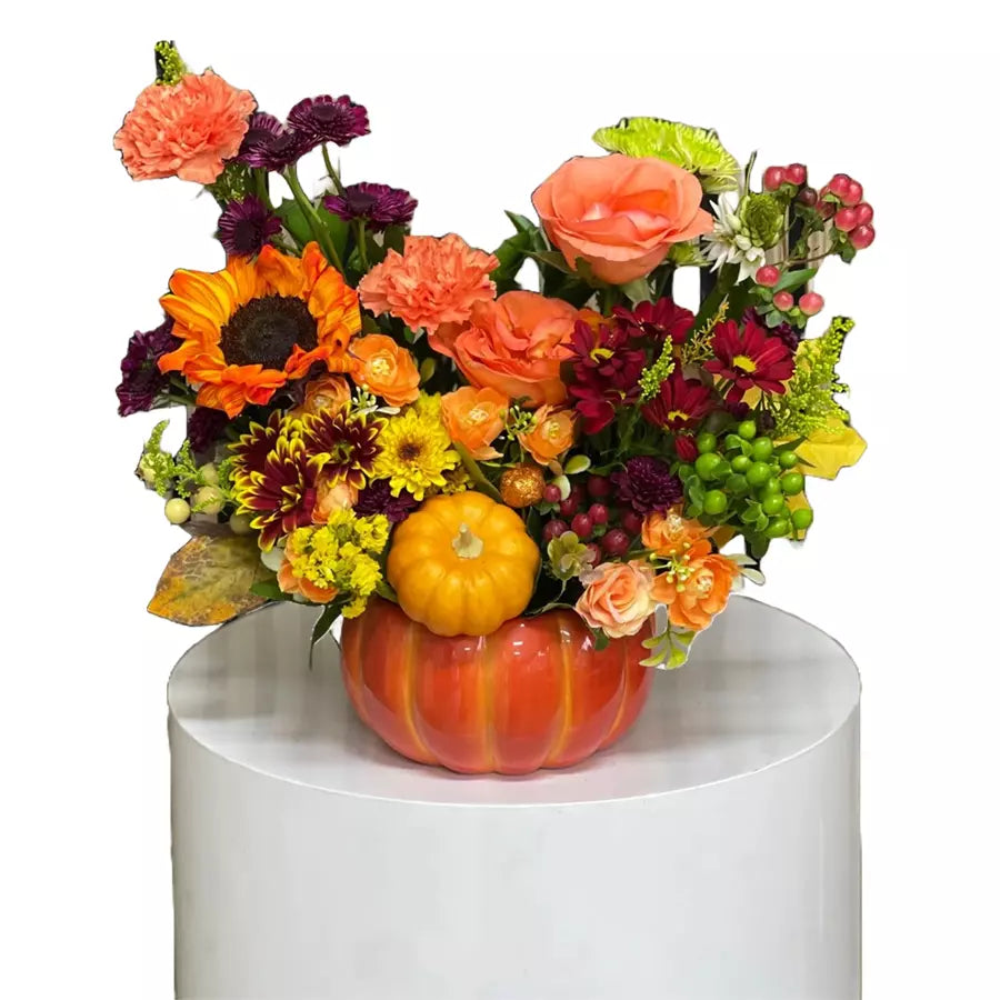 Autumn Flowers in Pumpkin Base. This beautiful arrangement of autumn flowers in a pumpkin base will bring the colors and scents of the season into your home. Bouquets Flowers Miami