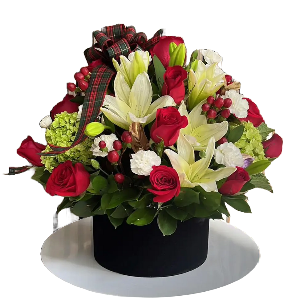 The image is of our floral arrangement with roses, lilies and carnations, we decorate them in a box with a Christmas theme, our flower shop is located in Doral, Miami. Bouquets Flowers