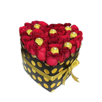 Image of heart-shaped box with red roses and chocolates chocolates, flower gift for Christmas, florist in Miami, Bouquets Flowers, image from above.