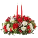 We present in this image our seasonal centerpiece, we made it with red roses, white carnations and daisies, the decoration is accompanied by two candles to decorate the dining table of your home. Our flower shop is located in the city of Miami. Bouquets Flowers, Size Deluxe.