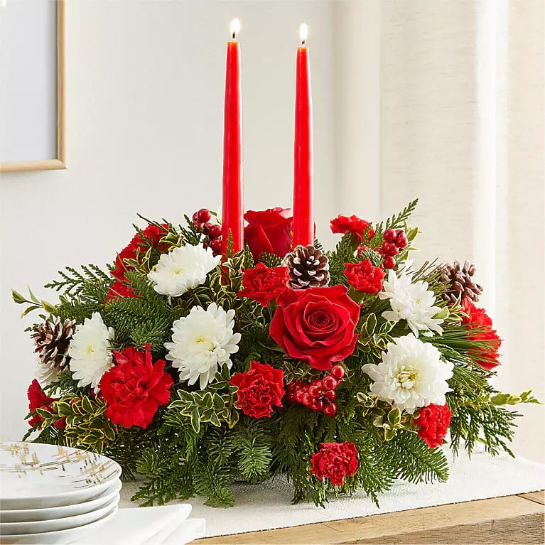 We present in this image as a real sample of our seasonal centerpiece, this view is the detail of the red roses, carnations and white daisies, ideal for decorating the dining table of your home. Our flower shop is located in the city of Miami. Bouquets Flowers